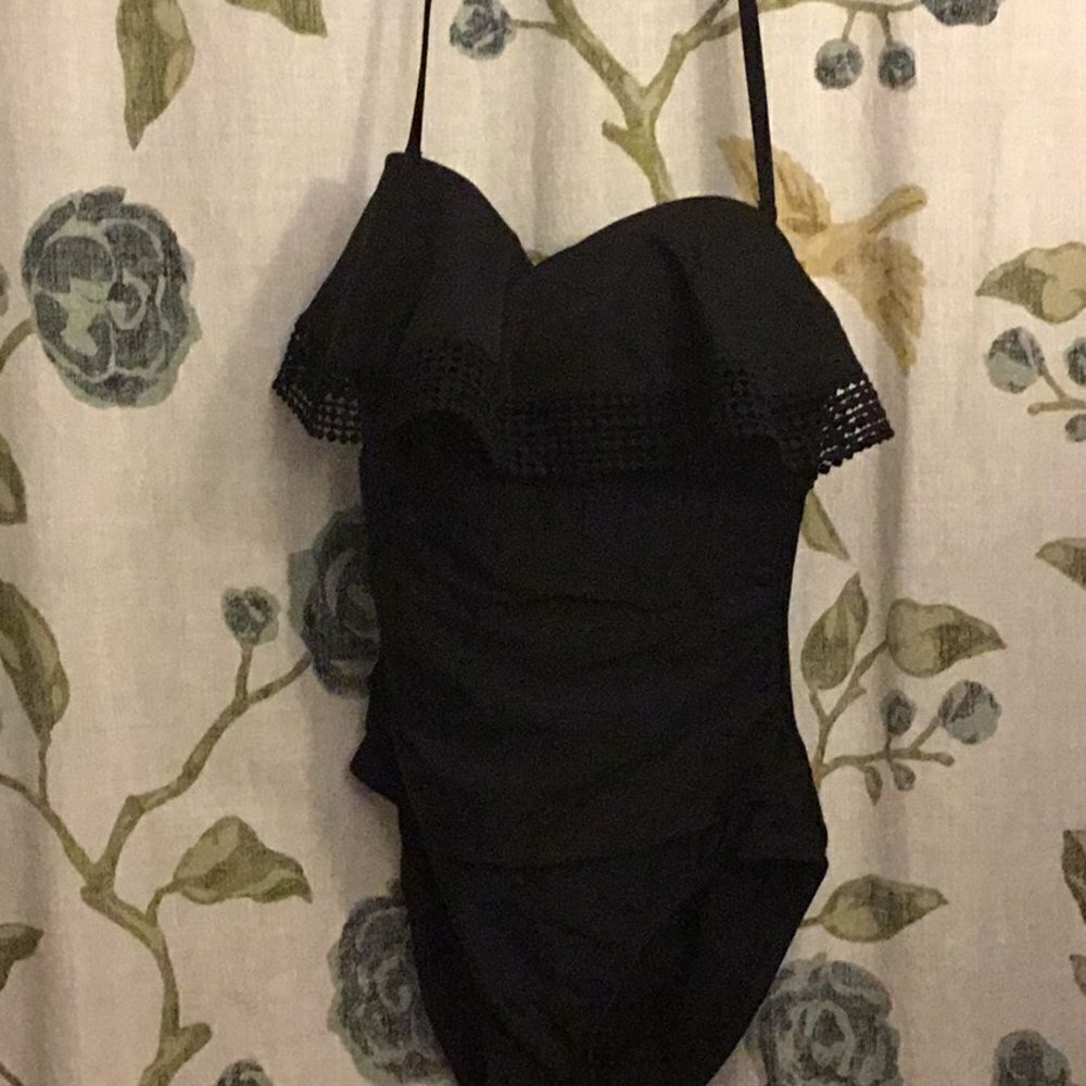 Womens one piece black swimsuit with ruffles.